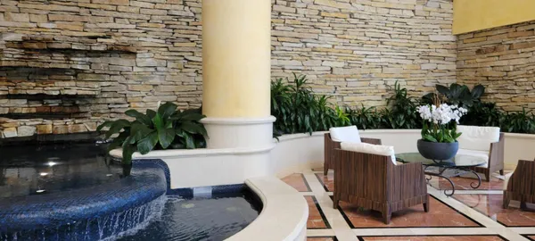 a view of a patio with table and chairs and potted plants