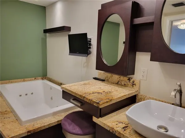 a bathroom with a tub and a sink