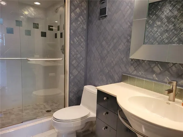 a bathroom with a sink toilet and shower
