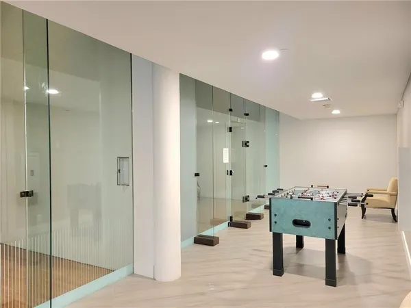 a hallway with a table and chairs