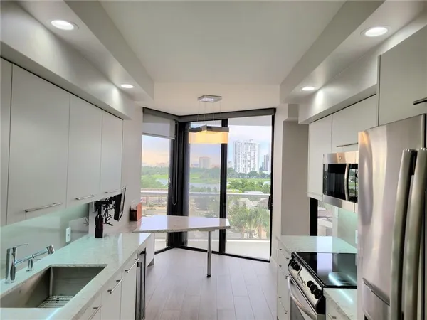 a view of a kitchen with a large window