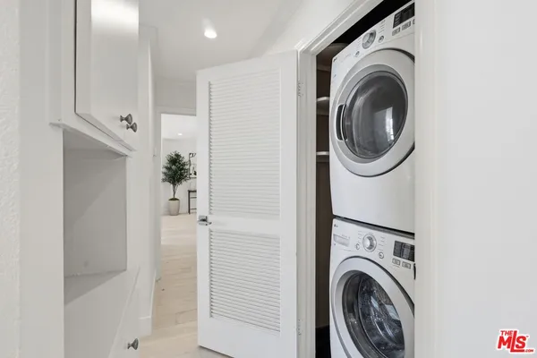 a view of a hallway with washer and dryer