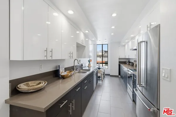 a kitchen with a sink appliances and cabinets