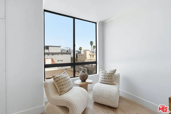 a bedroom with bed and glass window