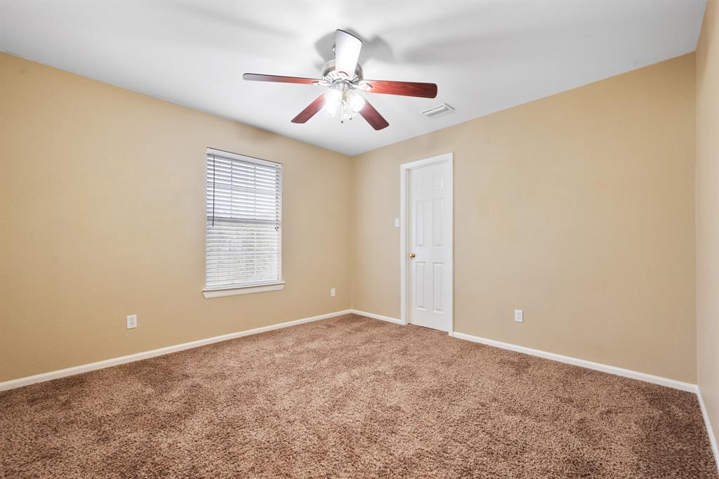 7517 Point Reyes Drive Fort Worth, TX 76137 - Photo 18 of 30 Carpeted interior room featuring neutral wall tones, a ceiling fan with light fixture, and a single window with blinds