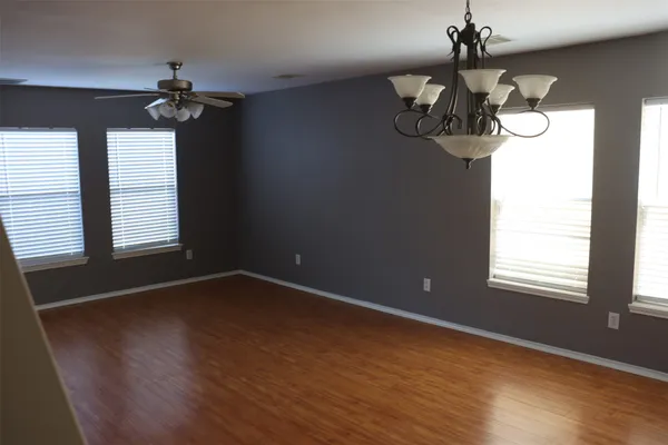 a view of a room with wooden floor and window