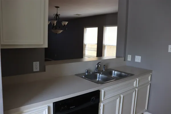 a kitchen with a sink and cabinets