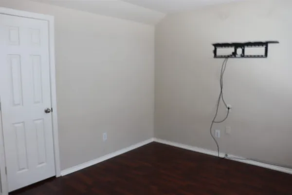 a view of a room with wooden floor