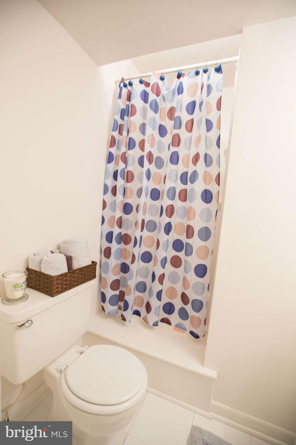 2226 Lofty Heights Place Reston, VA 20191 - Photo 16 of 25 a white toilet sitting next to a shower curtain