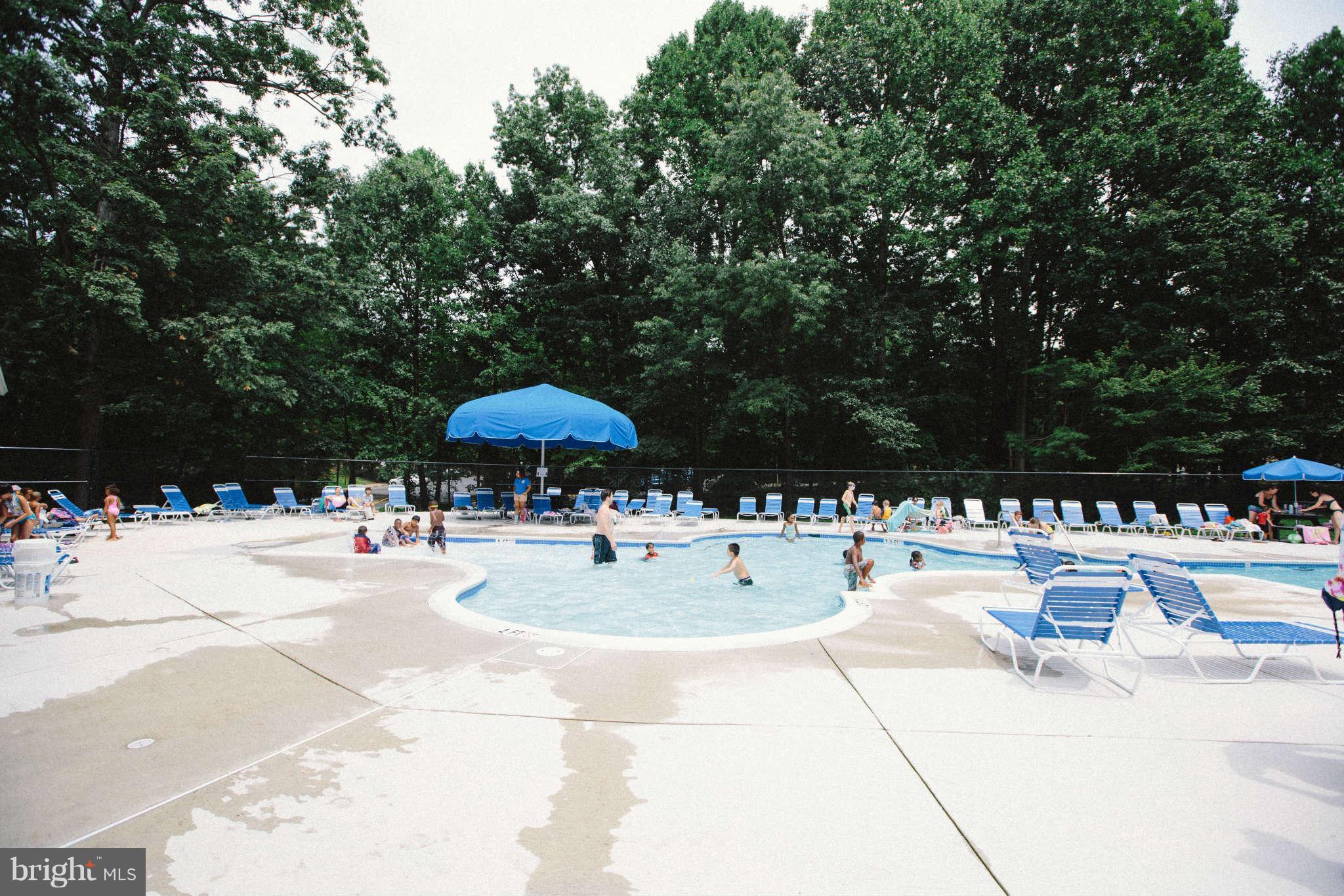 2226 Lofty Heights Place Reston, VA 20191 - Photo 22 of 25 a view of swimming pool with outdoor seating and trees