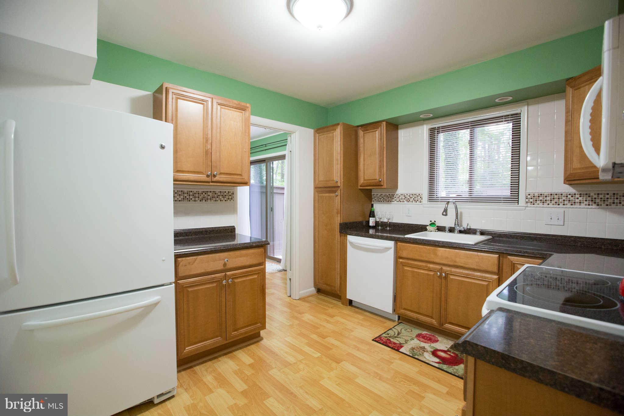 2226 Lofty Heights Place Reston, VA 20191 - Photo 6 of 25 a kitchen with granite countertop a refrigerator stove top oven and sink