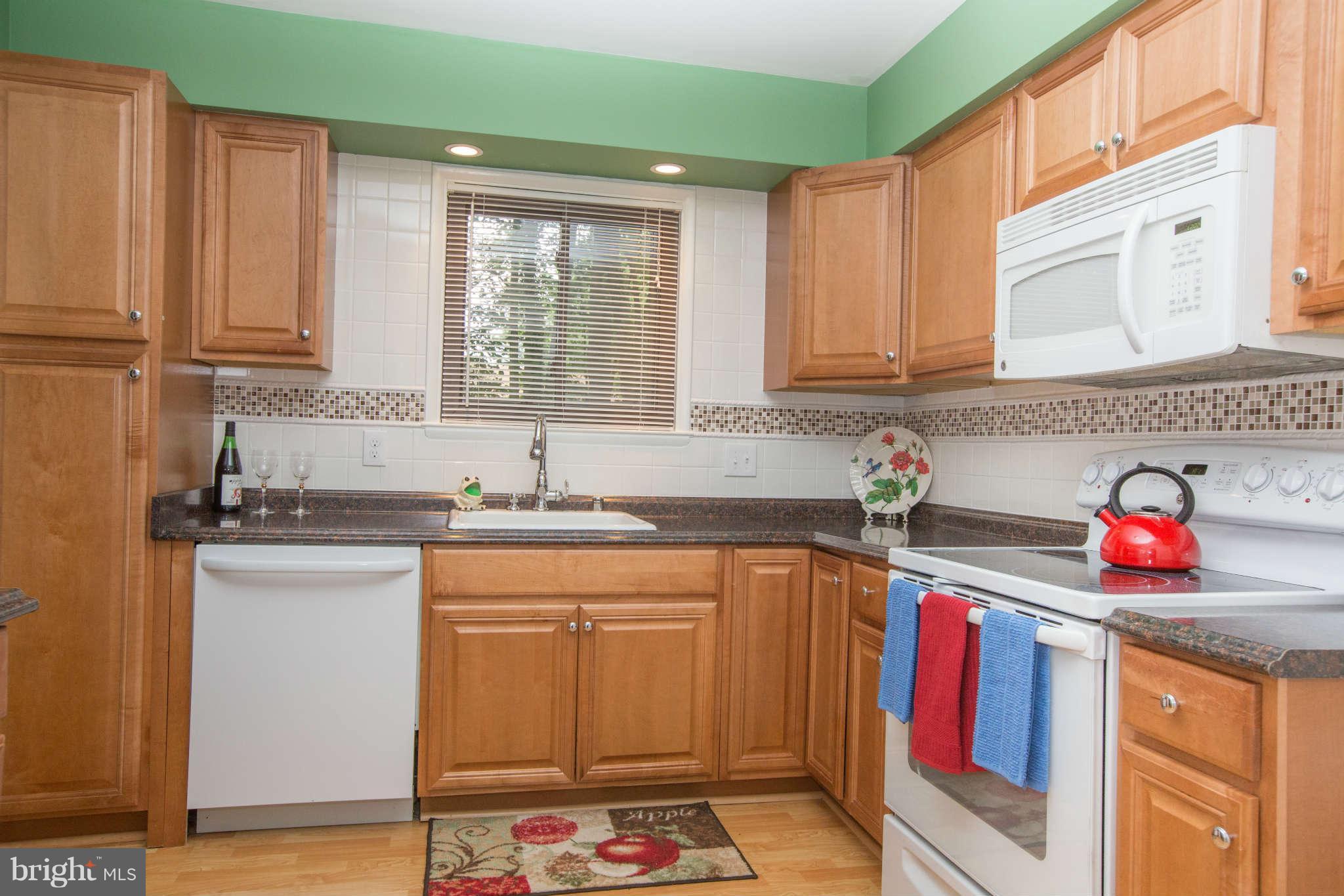 2226 Lofty Heights Place Reston, VA 20191 - Photo 8 of 25 a kitchen with stainless steel appliances granite countertop a sink stove and cabinets