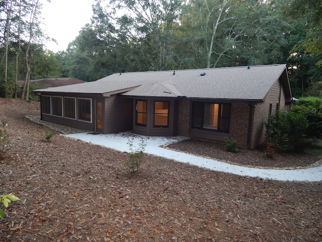 620 Downs Loop Clemson, SC 29631 - Photo 32 of 35 Mature trees frame a classic brick and siding exterior featuring a paved walkway.