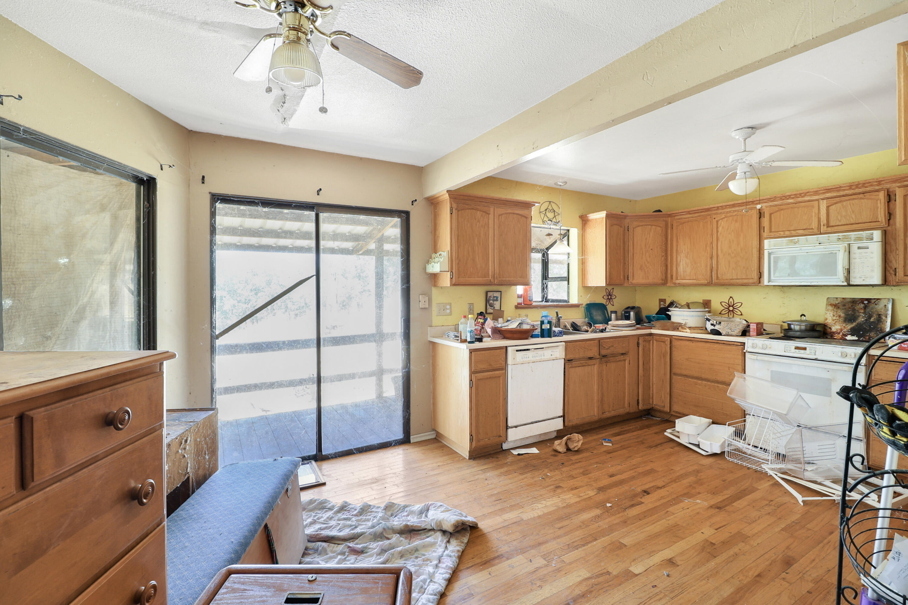 21217 Falling Oaks Road Redding, CA 96003 - Photo 11 of 24 a kitchen with a refrigerator and white cabinets