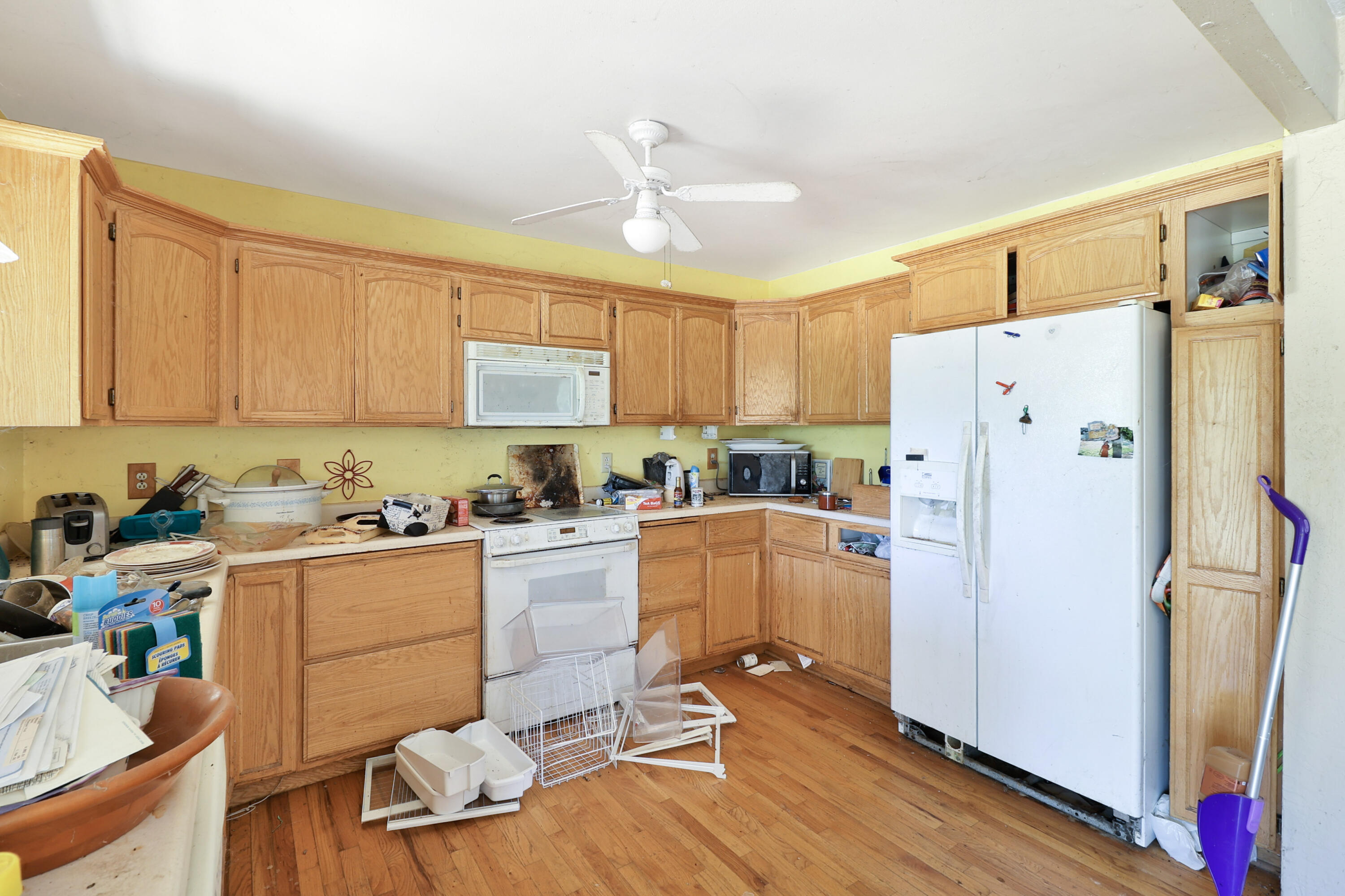 21217 Falling Oaks Road Redding, CA 96003 - Photo 10 of 24 a kitchen with a refrigerator a stove top oven a sink and cabinets