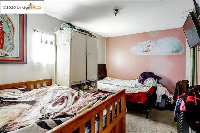 a kitchen with stainless steel appliances a stove a refrigerator and a dining table