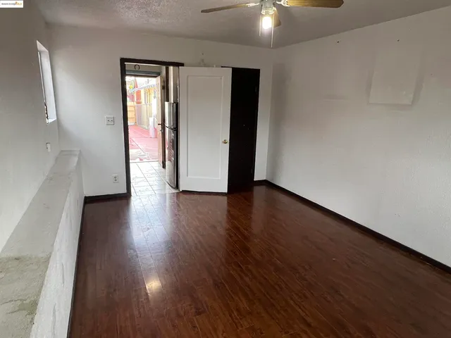 a kitchen with a refrigerator and a stove top oven