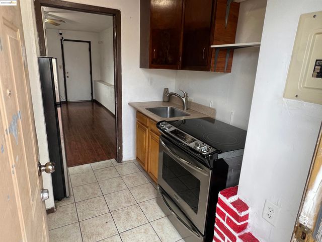 a kitchen with a refrigerator and a stove
