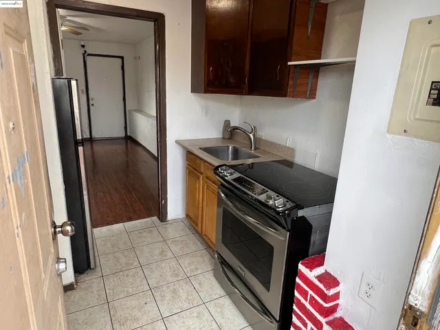 a kitchen with a refrigerator and a stove