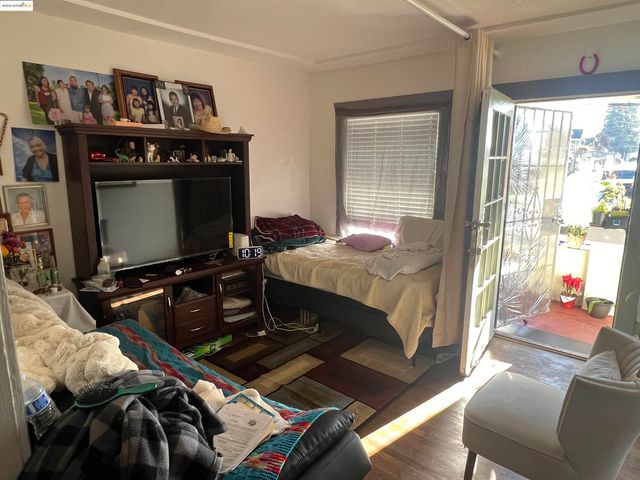 a bedroom with furniture and a flat screen tv