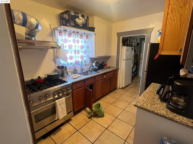 a kitchen with granite countertop a sink stove and cabinets
