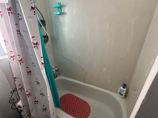 a bathroom with a tub and a shower