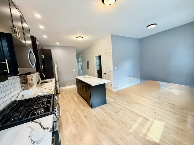 301 North Street, Unit 5 Boston, MA 02113 - Photo 3 of 18 a large bedroom with a large bed and a large mirror