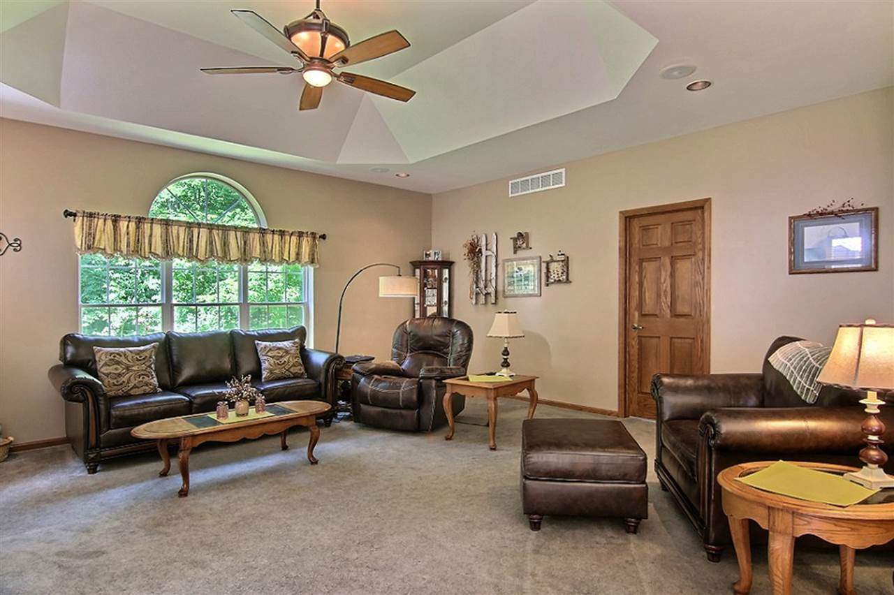 11936 Wheeler Road Durand, IL 61024 - Photo 4 of 25 a living room with furniture a fireplace and a large window