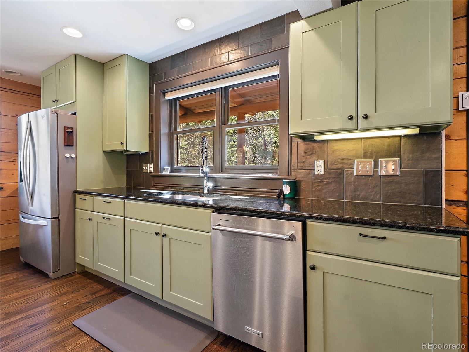 24 Pine Valley Road Evergreen, CO 80439 - Photo 6 of 50 a kitchen with stainless steel appliances granite countertop a sink and a refrigerator