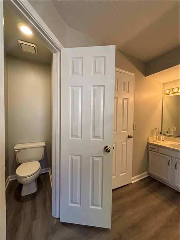 4949 Penscot Way Stone Mountain, GA 30088 - Photo 31 of 40 a bathroom with a granite countertop sink and a toilet