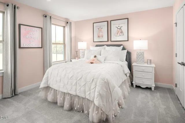 a bedroom with a bed a painting on the wall and a window