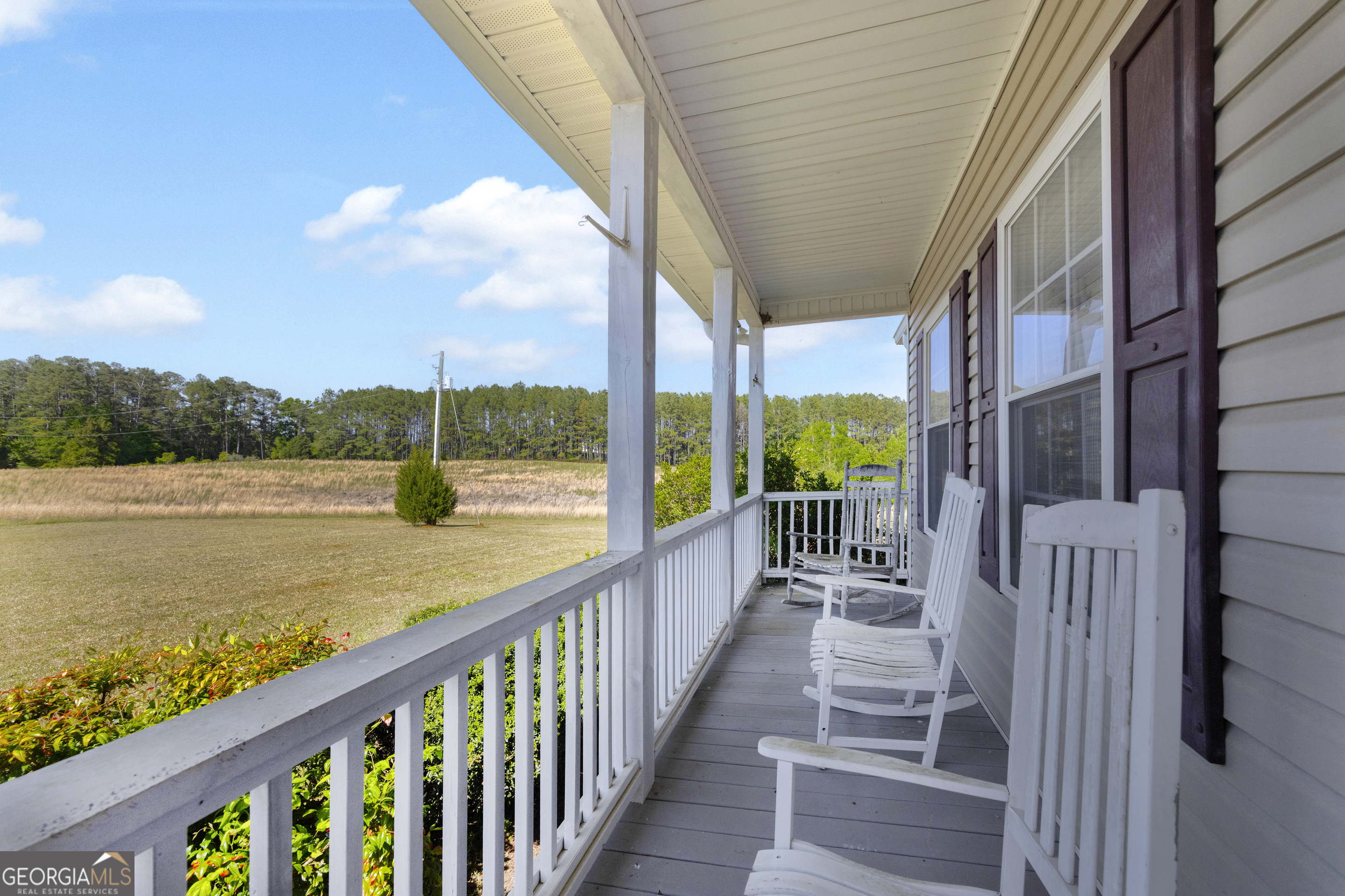 3248 Metasville Road Washington, GA 30673 - Photo 16 of 97 a view of a porch with wooden floor and fence next to a yard