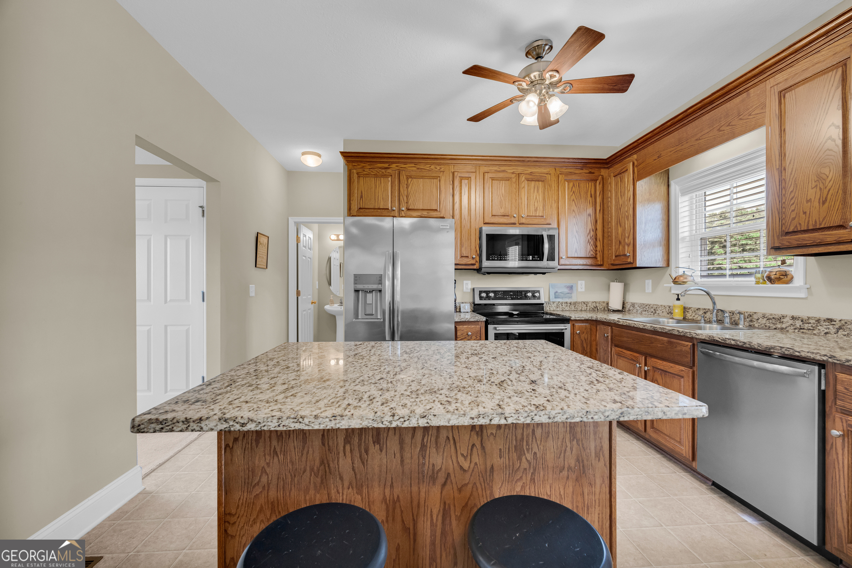 3248 Metasville Road Washington, GA 30673 - Photo 35 of 97 a kitchen with kitchen island granite countertop cabinets and stainless steel appliances