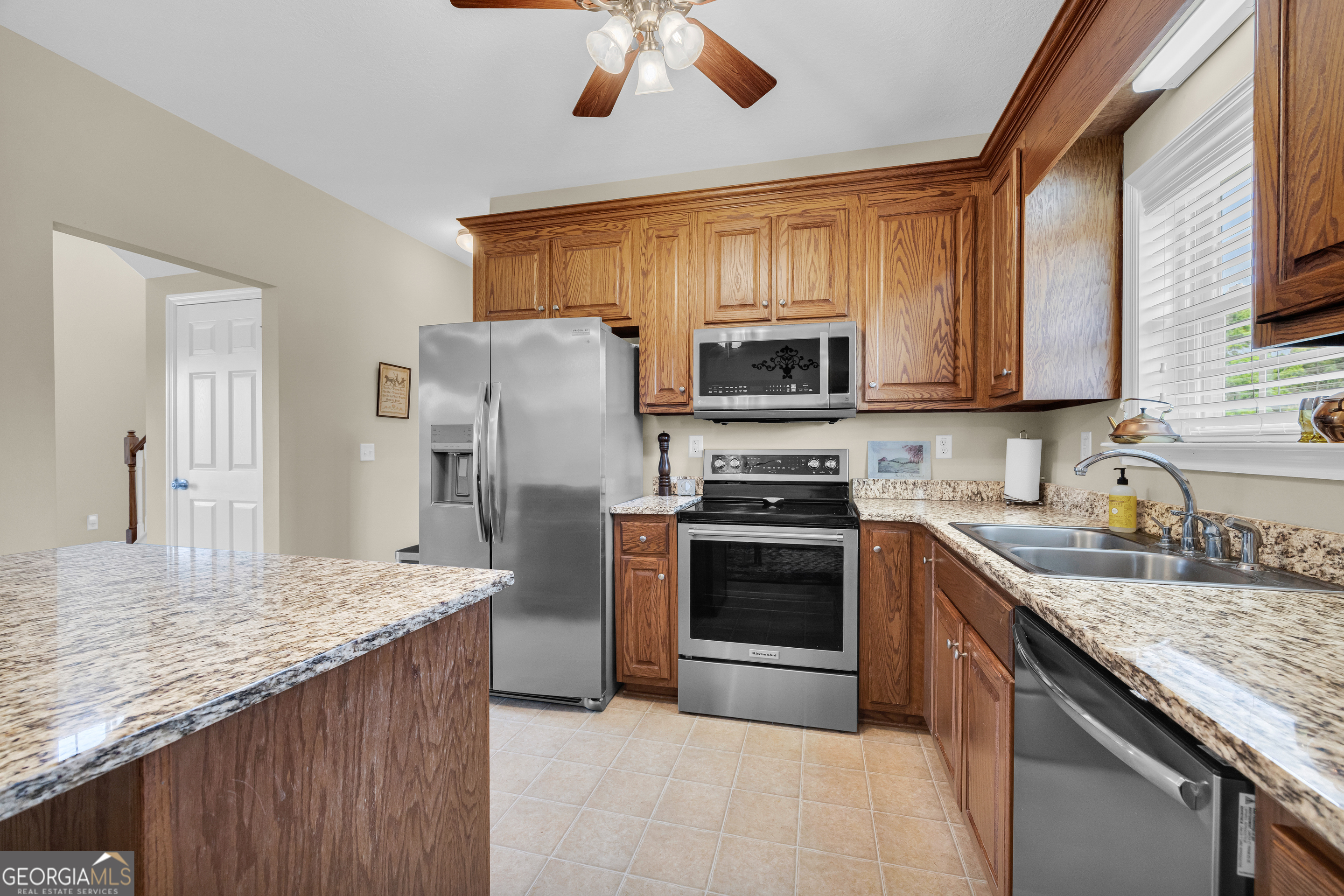 3248 Metasville Road Washington, GA 30673 - Photo 41 of 97 a kitchen with stainless steel appliances granite countertop a stove refrigerator sink and microwave