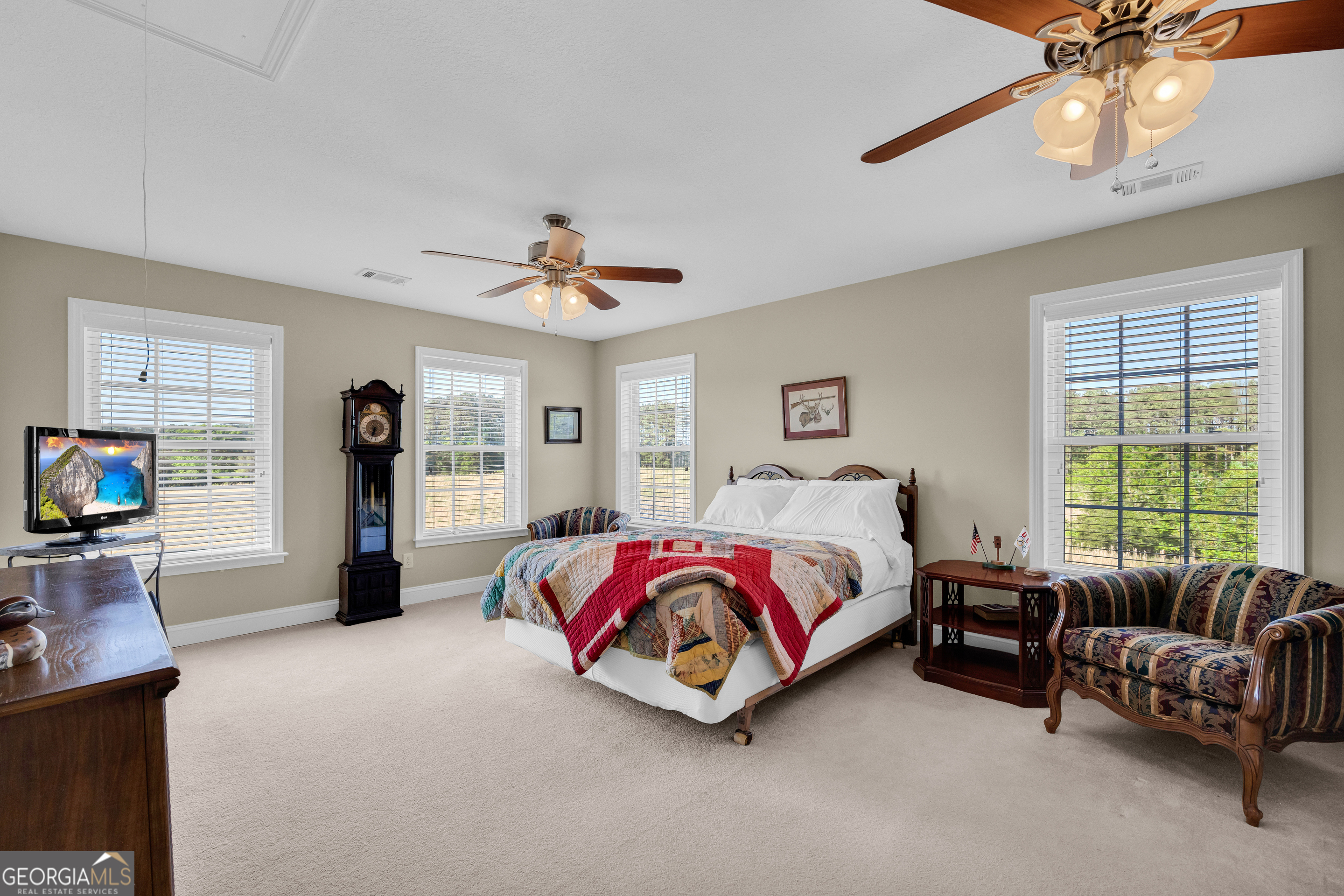 3248 Metasville Road Washington, GA 30673 - Photo 66 of 97 a spacious bedroom with a bed and a couch