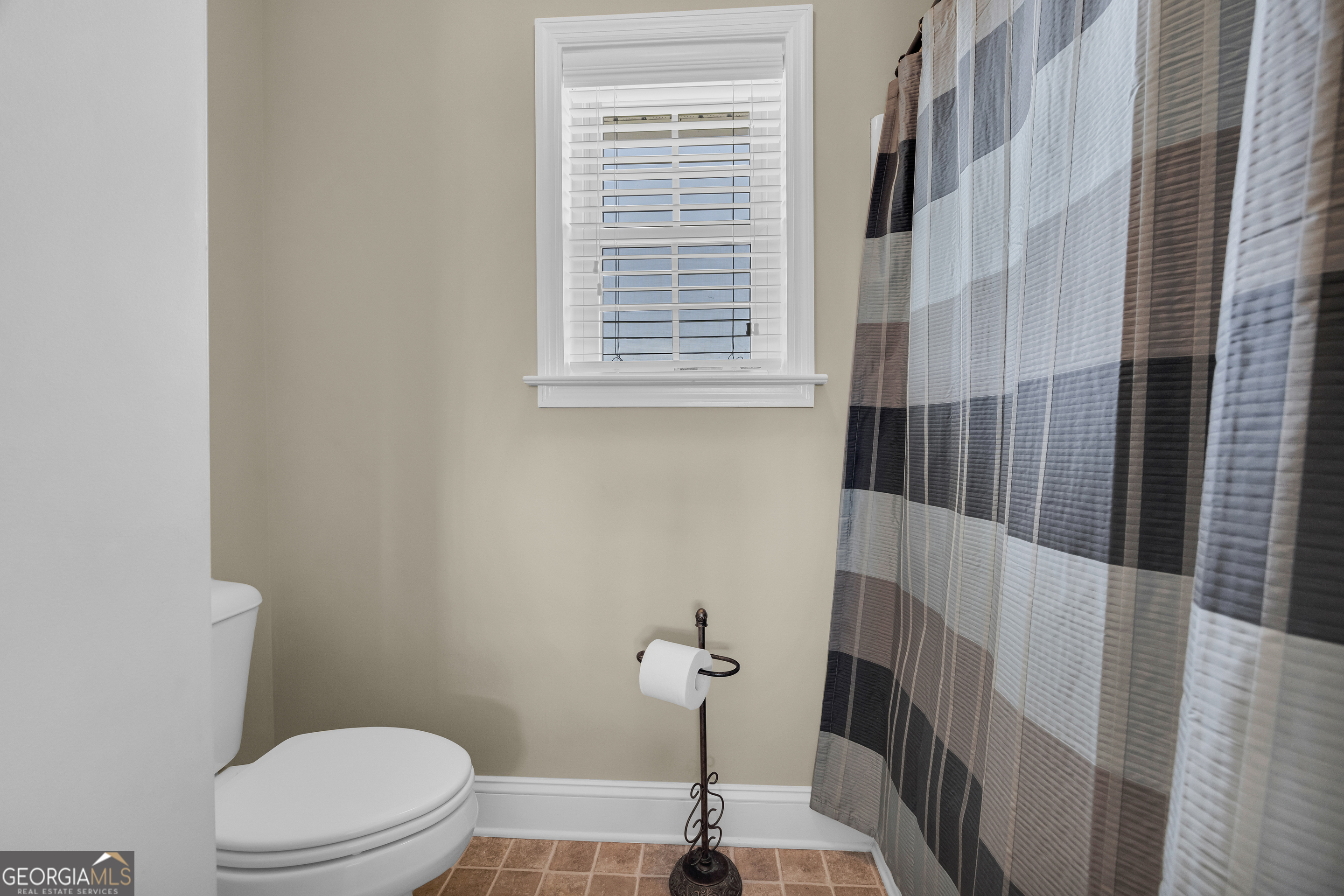 3248 Metasville Road Washington, GA 30673 - Photo 73 of 97 a bathroom with a window a toilet and a shower