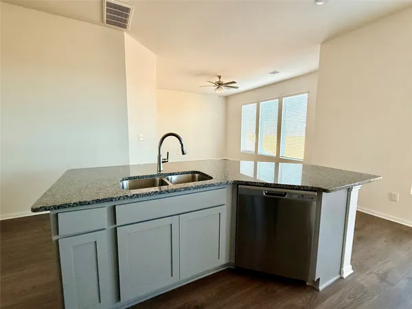 a kitchen with a sink and cabinets