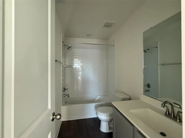 a bathroom with a sink mirror toilet and bathtub