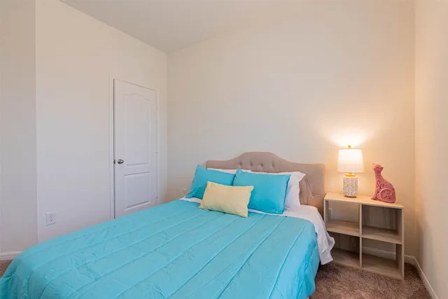 a bedroom with a bed and a mirror