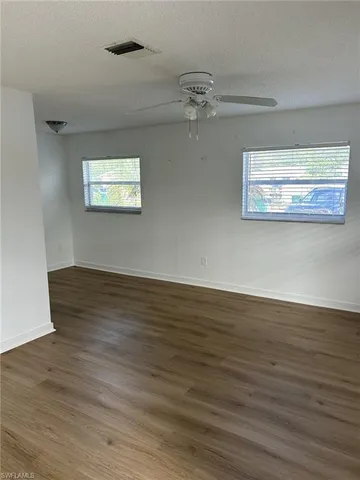 a view of a room with wooden floor