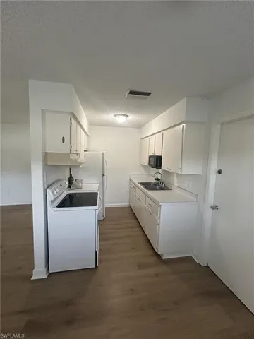 a kitchen with sink cabinets and stainless steel appliances