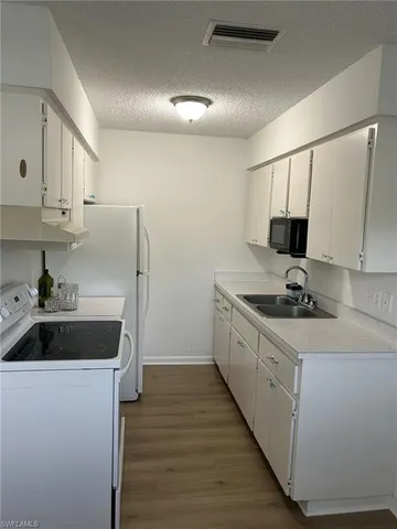 a kitchen with a sink cabinets and stainless steel appliances