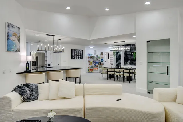 a living room with furniture a fireplace and a table