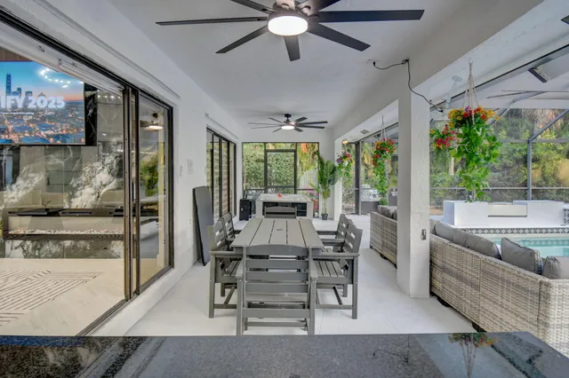 a living room with furniture kitchen view and a chandelier