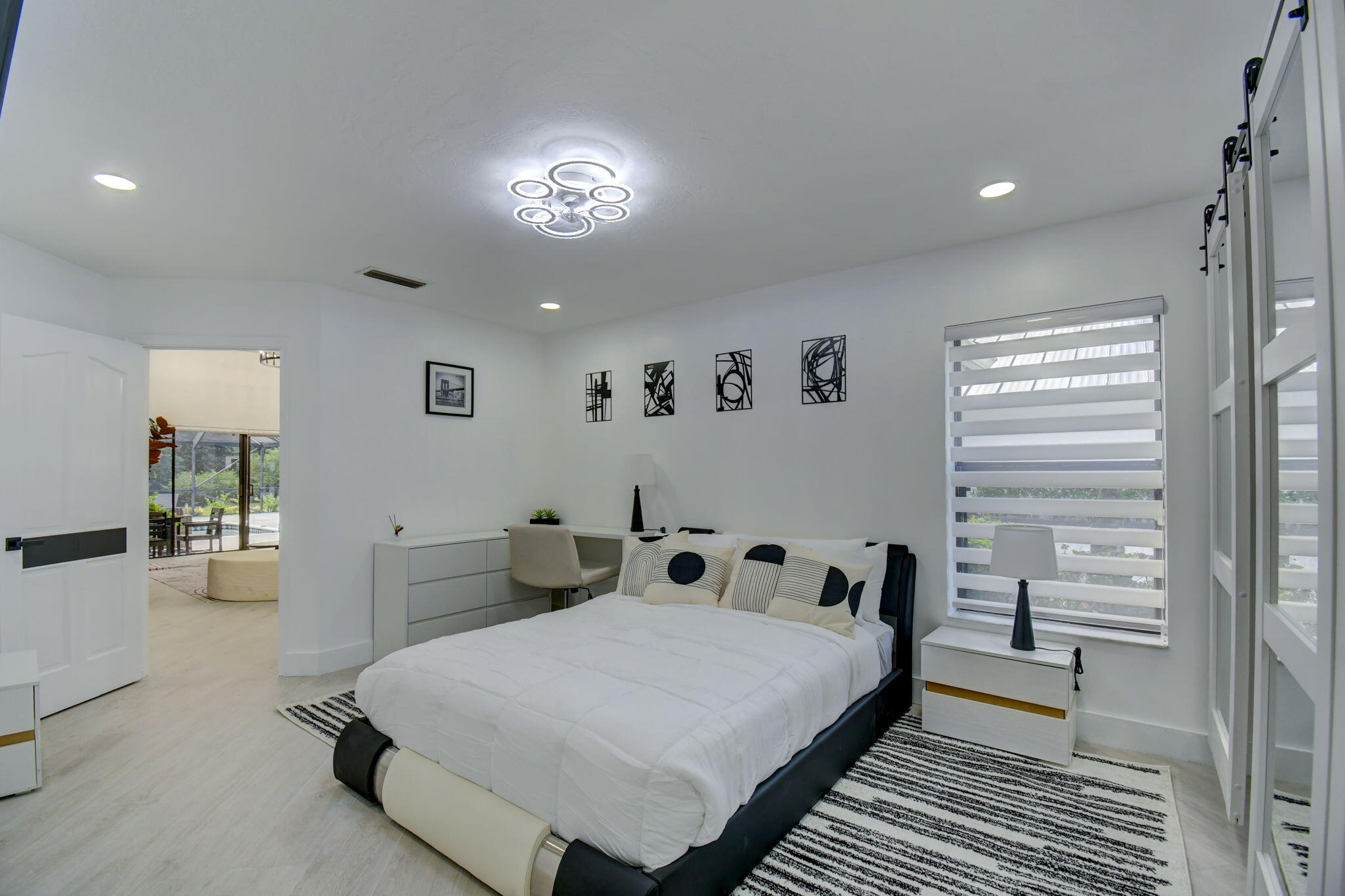 13302 Doubletree Circle Wellington, FL 33414 - Photo 26 of 82 a spacious bedroom with a bed and a chandelier