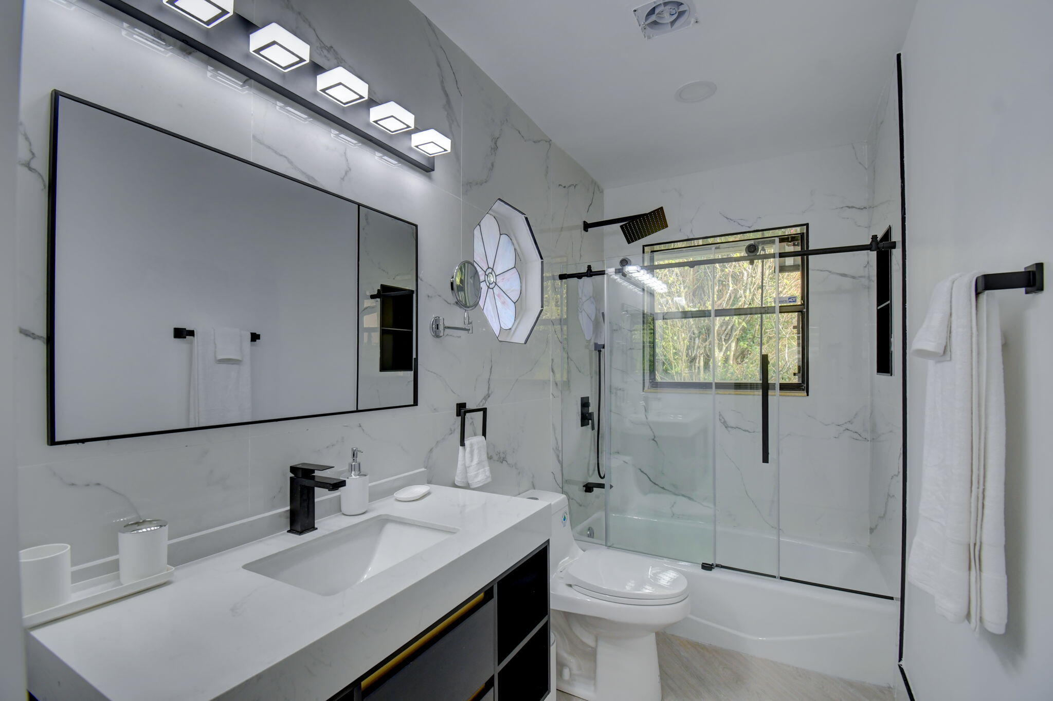 13302 Doubletree Circle Wellington, FL 33414 - Photo 27 of 82 a bathroom with a sink a toilet and shower