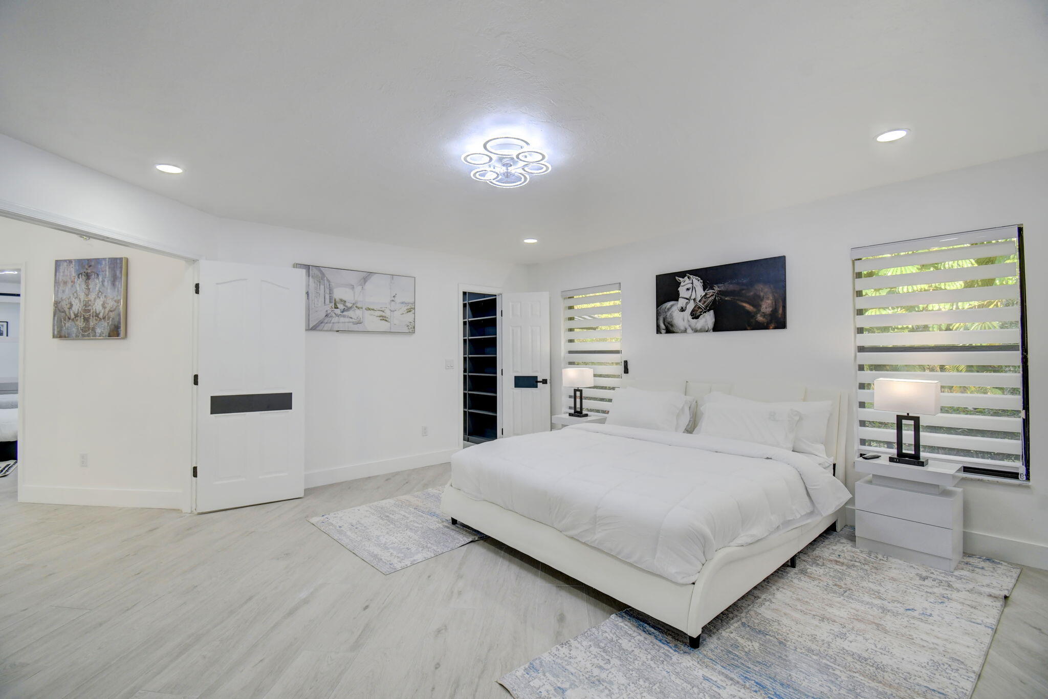 13302 Doubletree Circle Wellington, FL 33414 - Photo 49 of 82 a bedroom with a large bed and a night stand