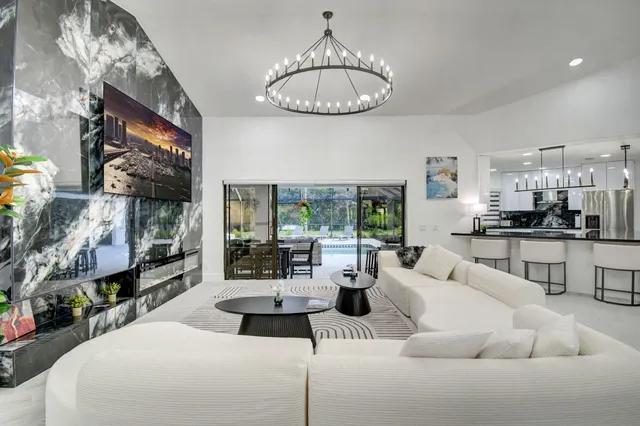 a view of a dining room with furniture wooden floor and chandelier