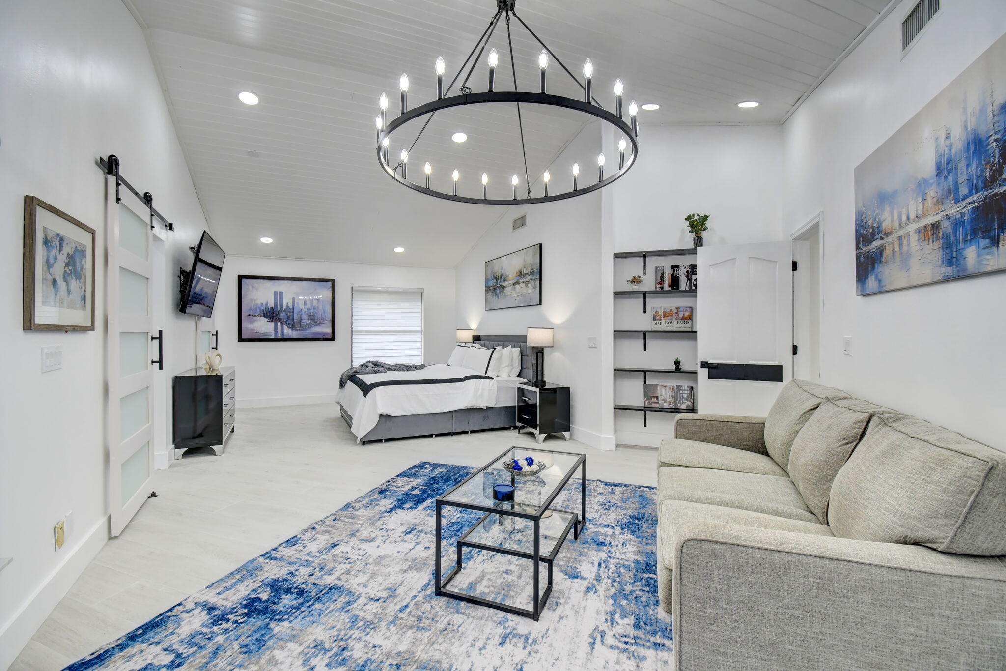 13302 Doubletree Circle Wellington, FL 33414 - Photo 52 of 82 a living room with furniture kitchen view and a chandelier