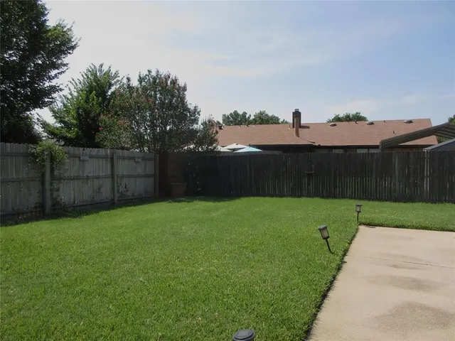 a view of a house with a yard and tree s